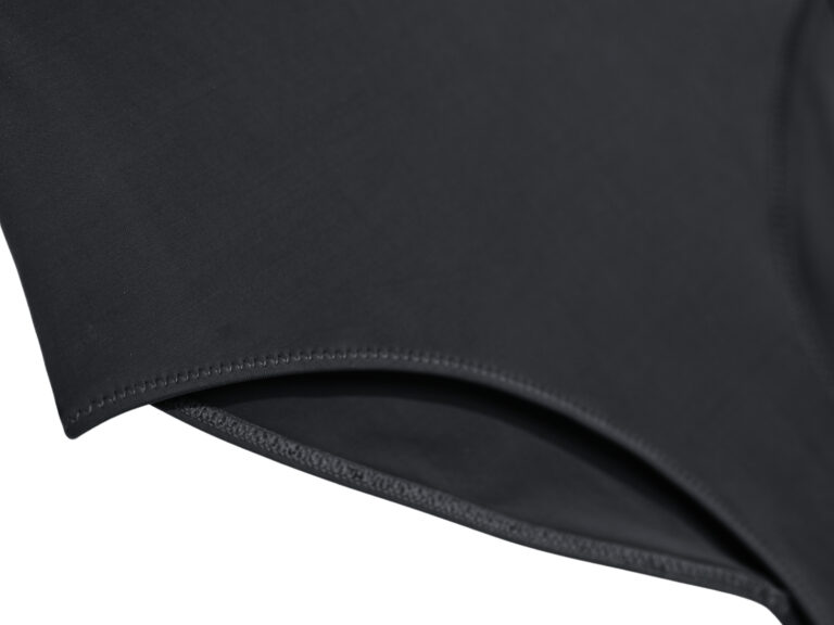 Elastic binding along the leg opening of the black one-piece