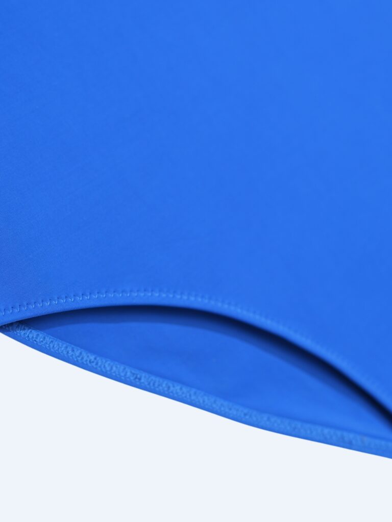 Flat-lay close-up of the elastic binding along the leg opening of the royal blue Gene one-piece