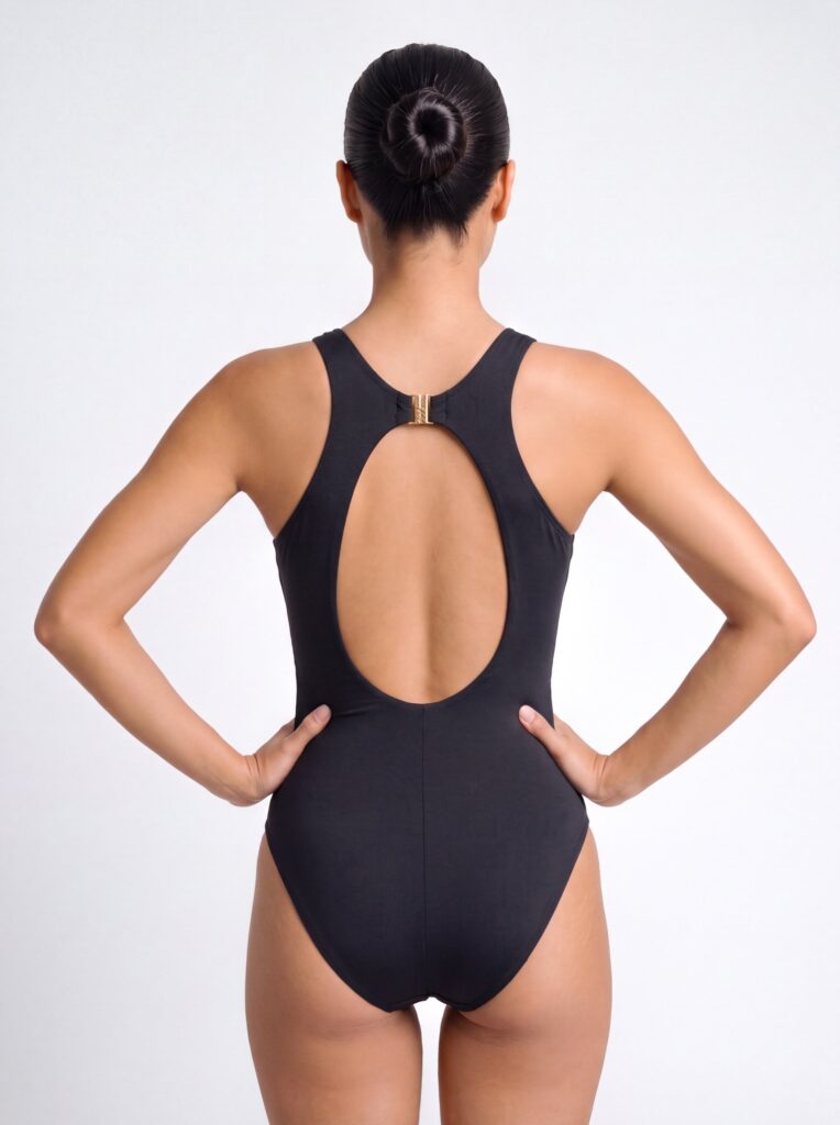 Back view of the black Gene one-piece with a mid-high cheeky leg
