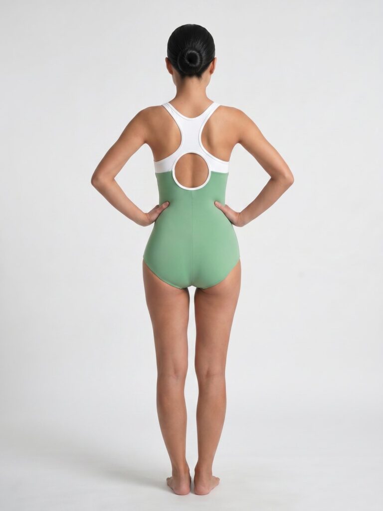 Studio back view of the white and matcha green Mira one-piece showing the round open back
