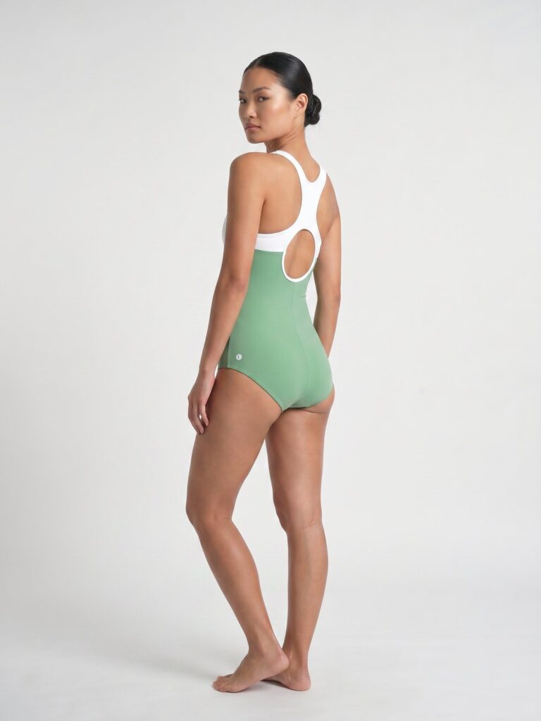 Studio side back view of the white and matcha green Mira high-neck one-piece
