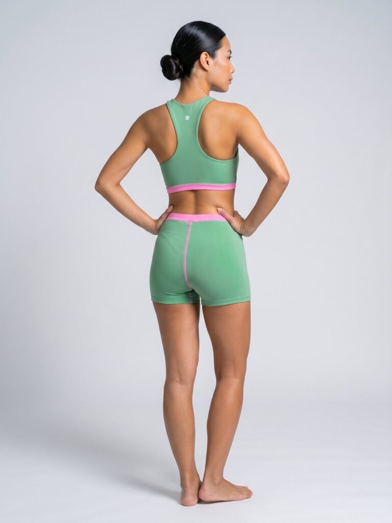 Studio back view of the Tenacy two-piece showing the racerback and full seat coverage