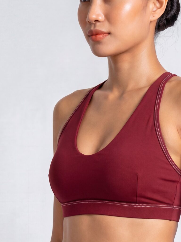 Close-up of the syrah red Cala U-neck swim top with a wide underbust band