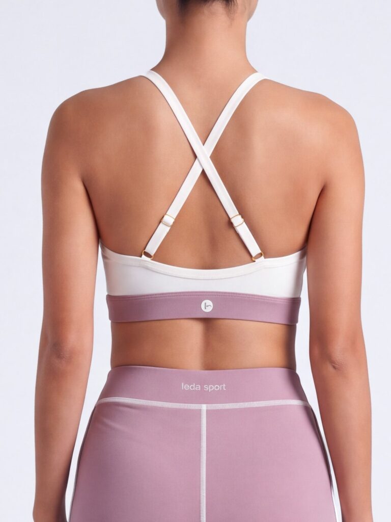 Close-up of the adjustable cross-back straps on the cream white Cala swim top