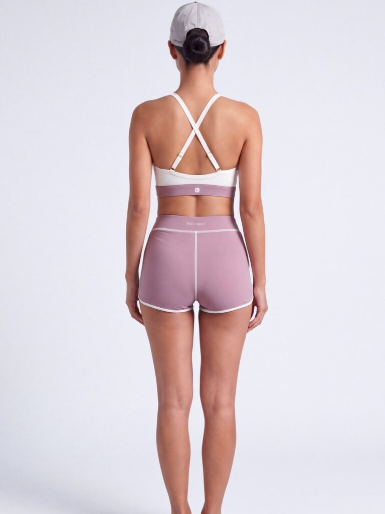 Studio back view of the cream white Cala swim top showing the adjustable cross-back straps