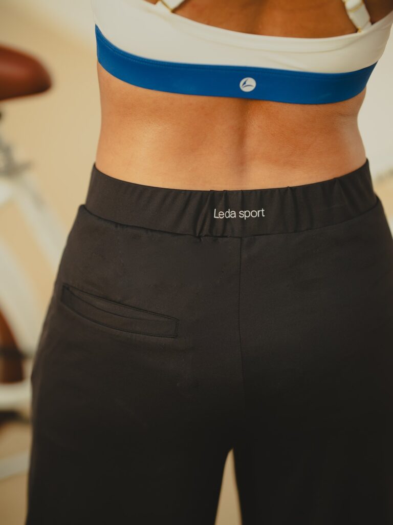 Close-up of the elastic waistband and back pocket of the black wide-leg pants