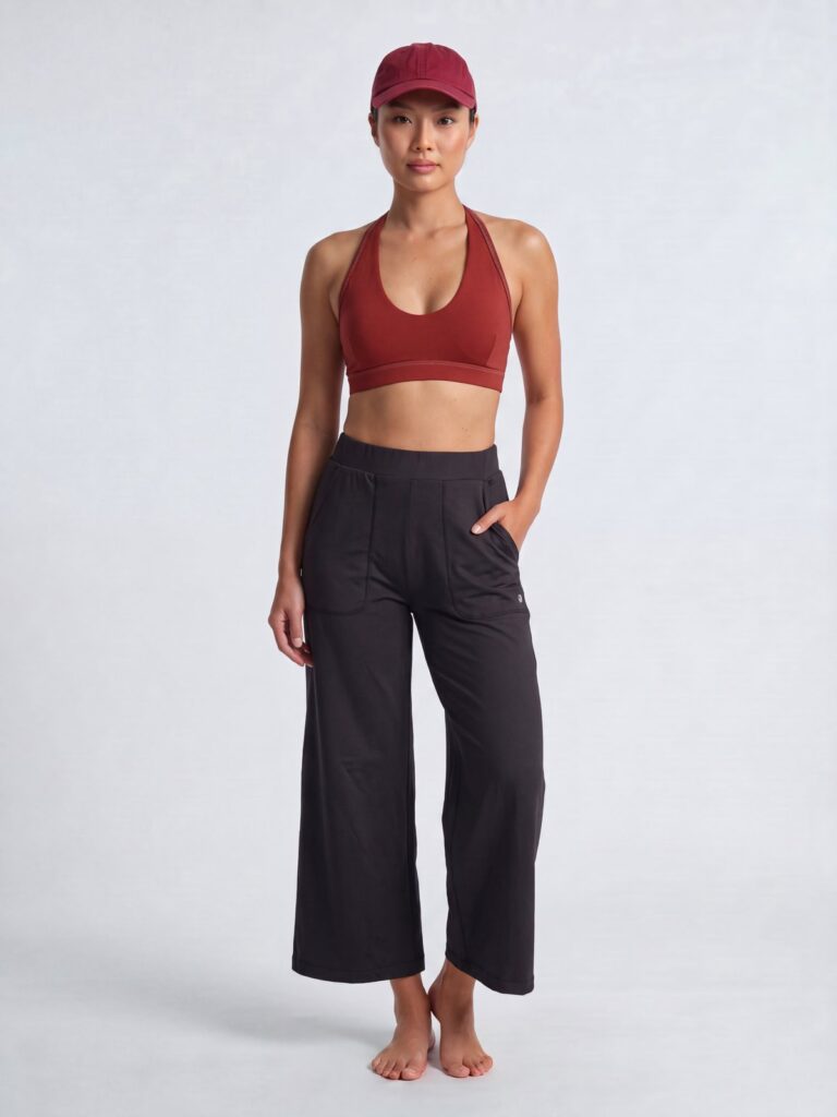 Studio front view of the black wide-leg cropped pull-on pants with a red swim top