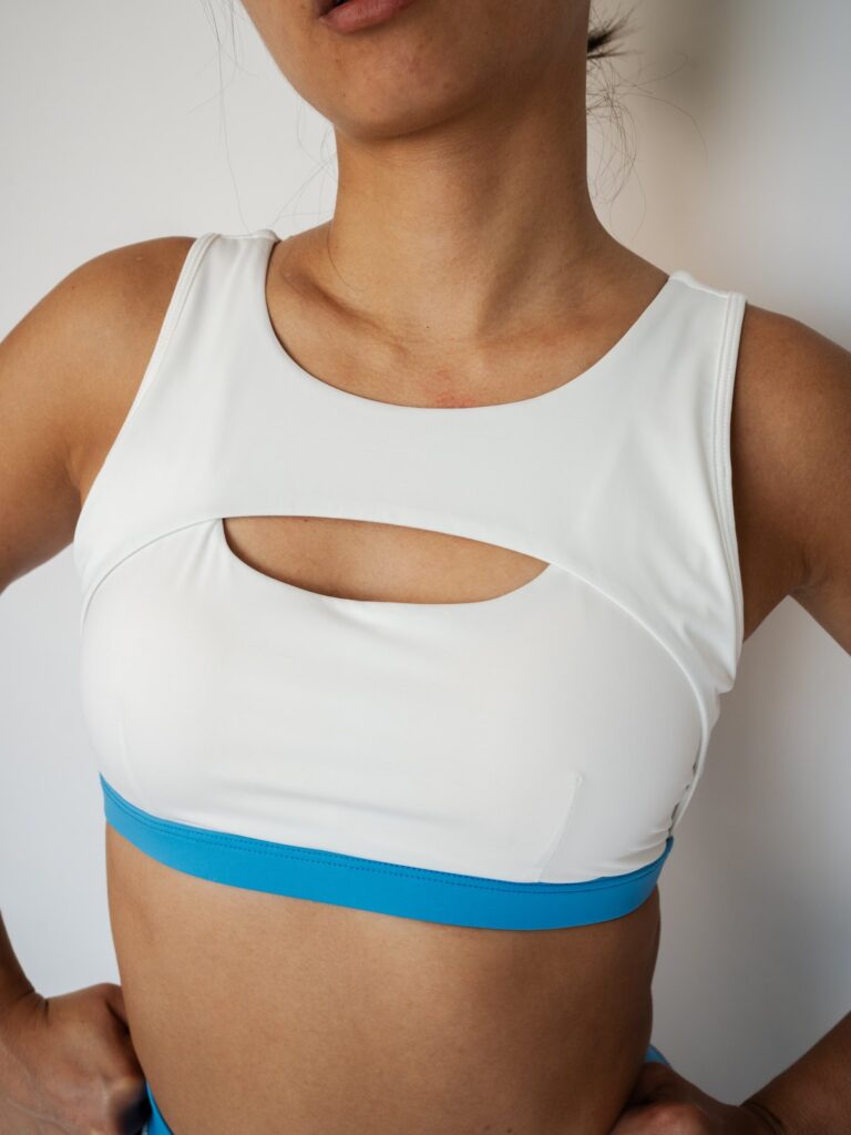Close-up of the cream white Siena swim top with wide straps and a blue underband