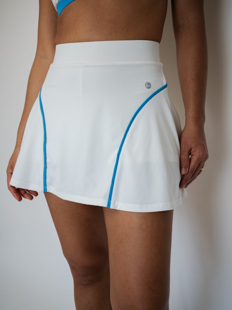Close-up of the cream white Siena high-waist skort with blue seam lines