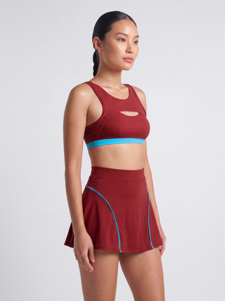 Model in the Siena swim top, three-quarter front view showing the wide straps and raised underarm