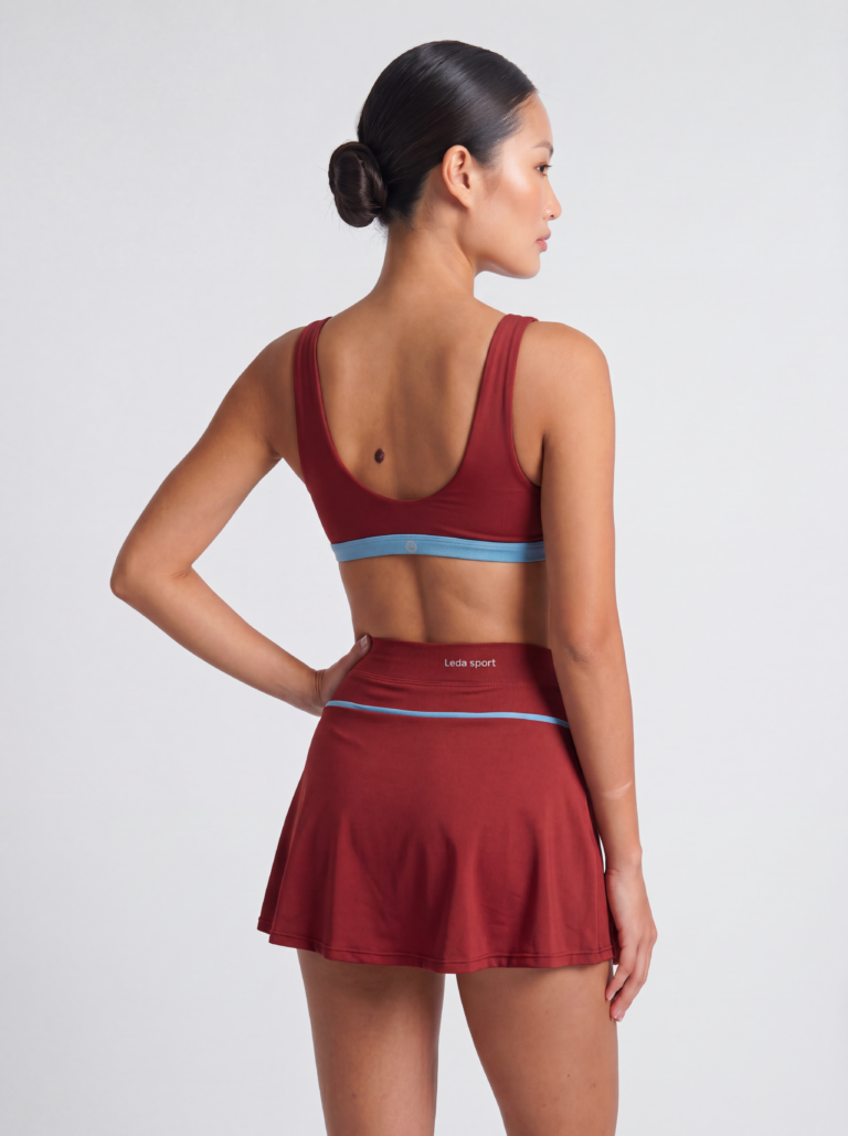 Three-quarter back view of the Siena skort and top on a model, showing the wide waistband