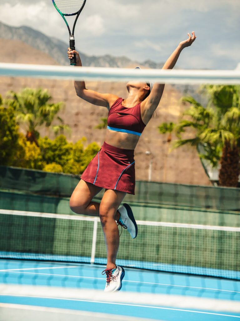 Woman wearing the Siena cutout swim top in syrah red