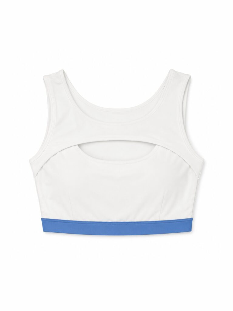 Flat lay of the Siena cutout color-block swim top in cream white with a blue underband